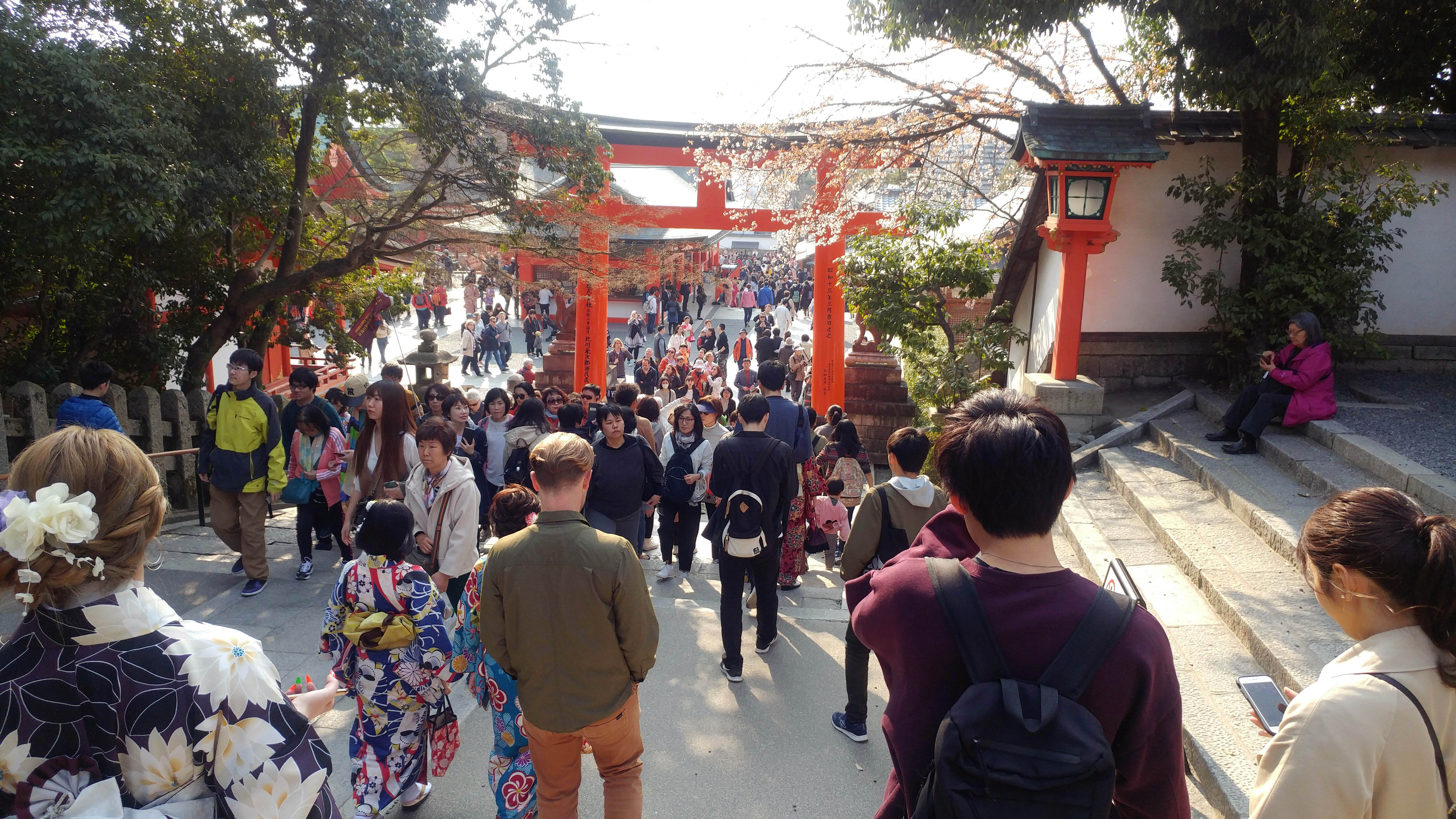 Crowds passing beneath the vermilion torii gates at Fushimi Inari shrine in Kyoto